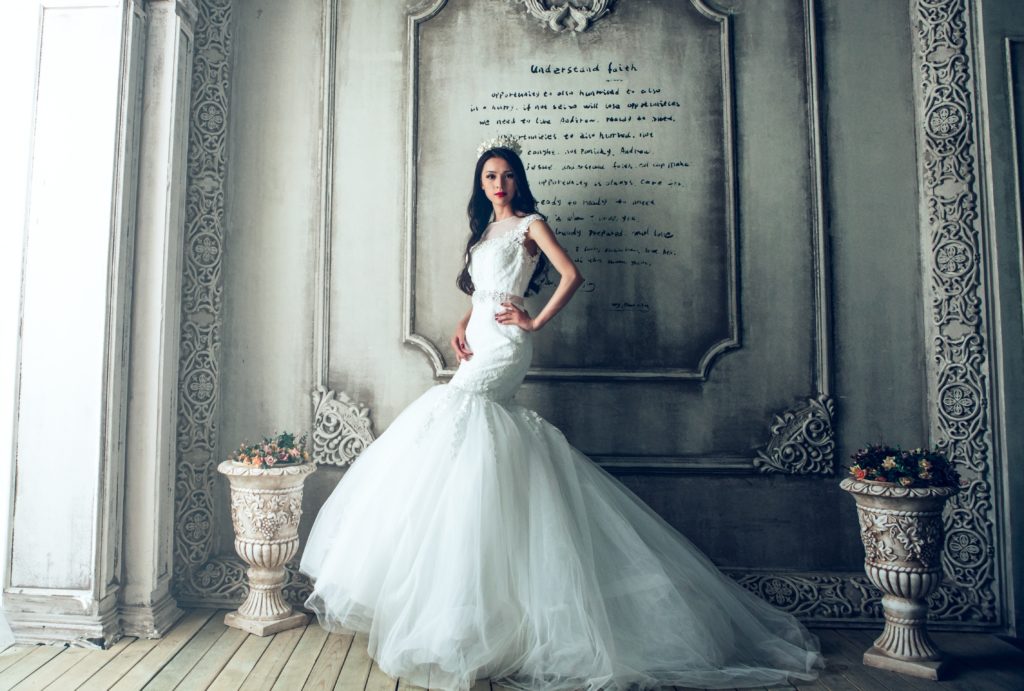 Bride posing with a wedding dress