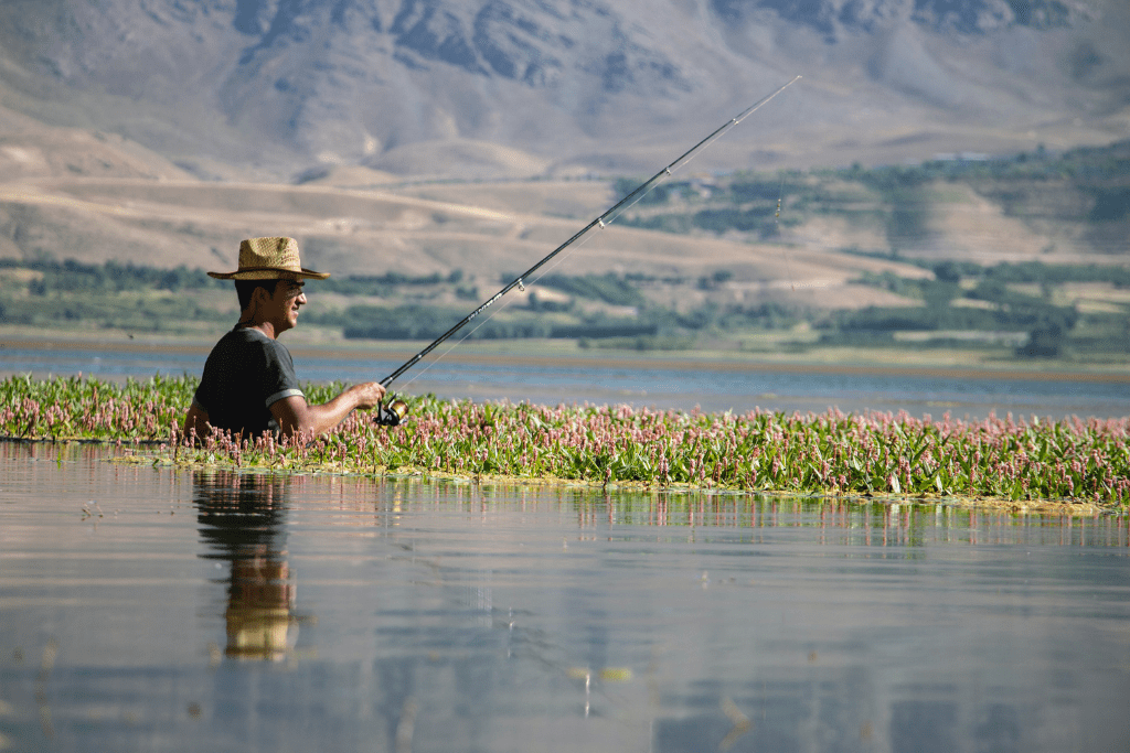 man fishing in a pond for a surplus catch